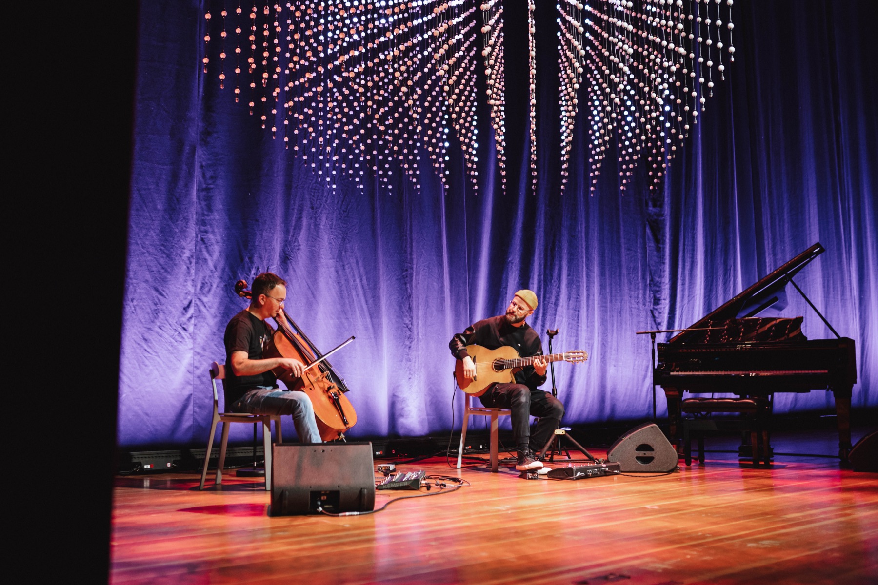 Pars Momentum live on stage beneath a light installation